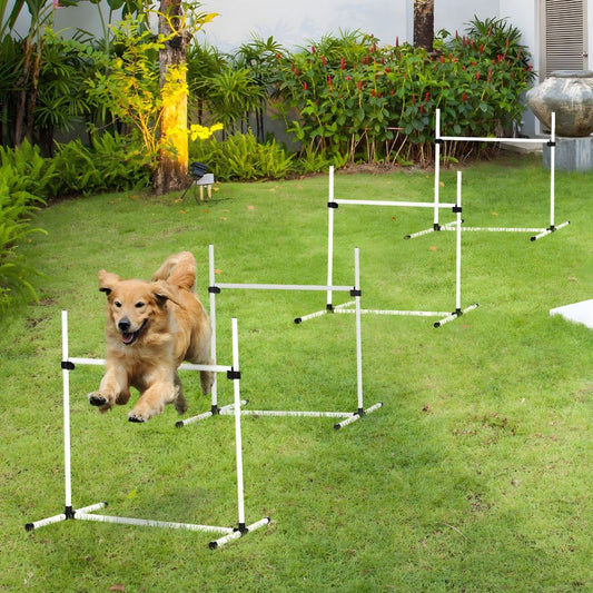 Golden Retriever actively participating in outdoor training by successfully jumping over a series of four Globopaw white agility hurdles on a grassy lawn.